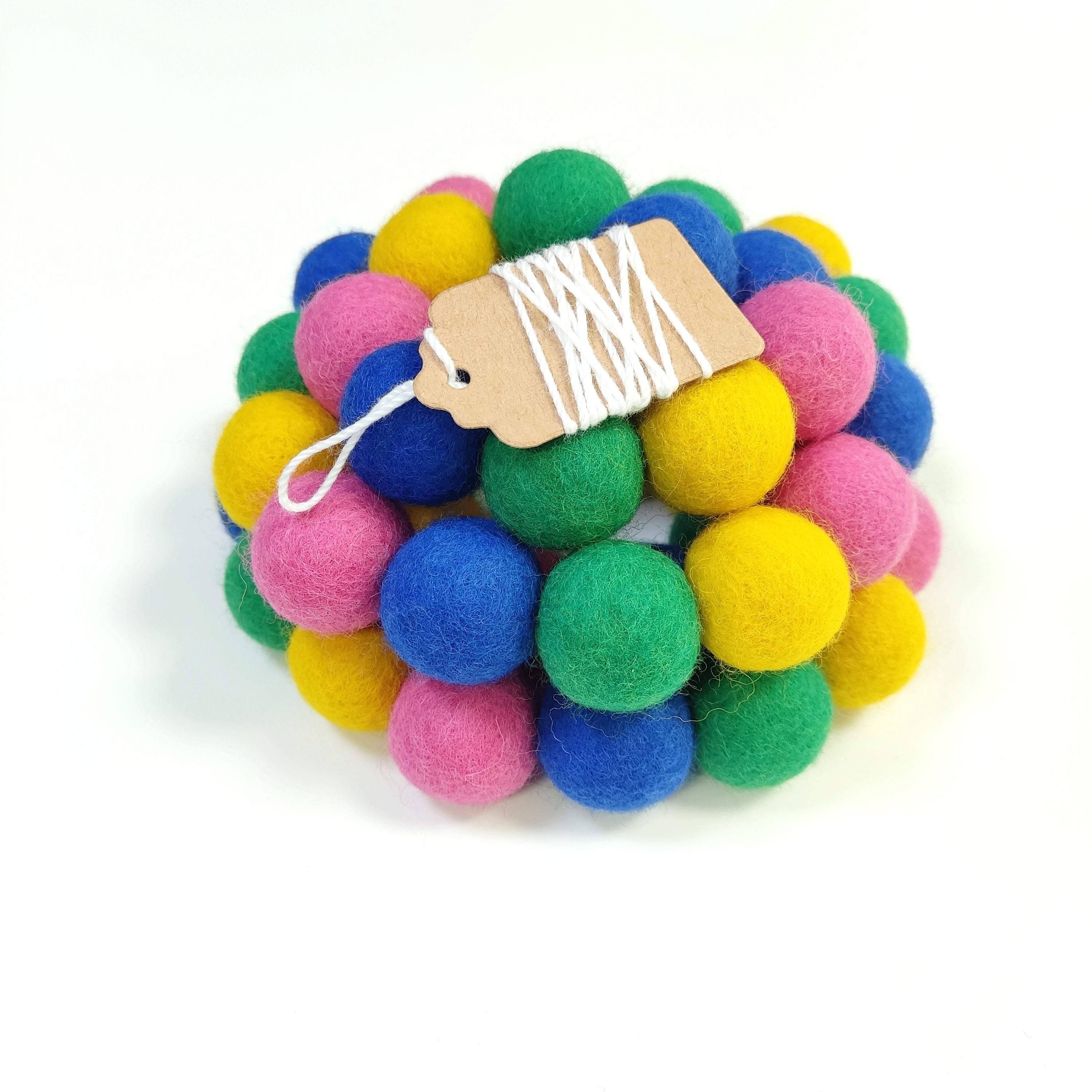 Zoom sur la guirlande de pompons en laine mérinos confettis avec étiquette CELAINEDECO